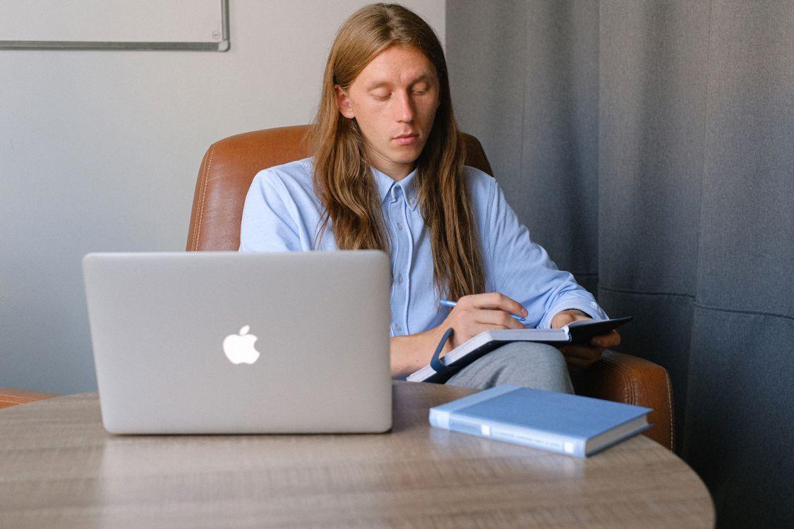 CPA candidate reviewing exam prep materials at a desk